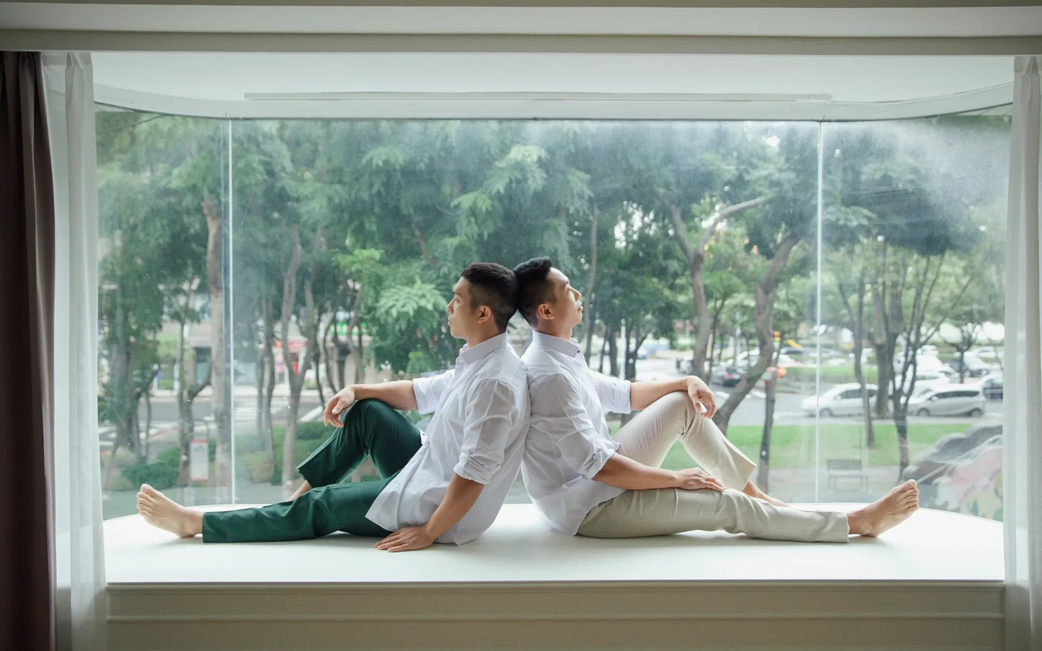 宇宙拿鐵 Lattefotos 男男婚紗：Josh 與 Roy 兩人並坐窗台看向窗外。